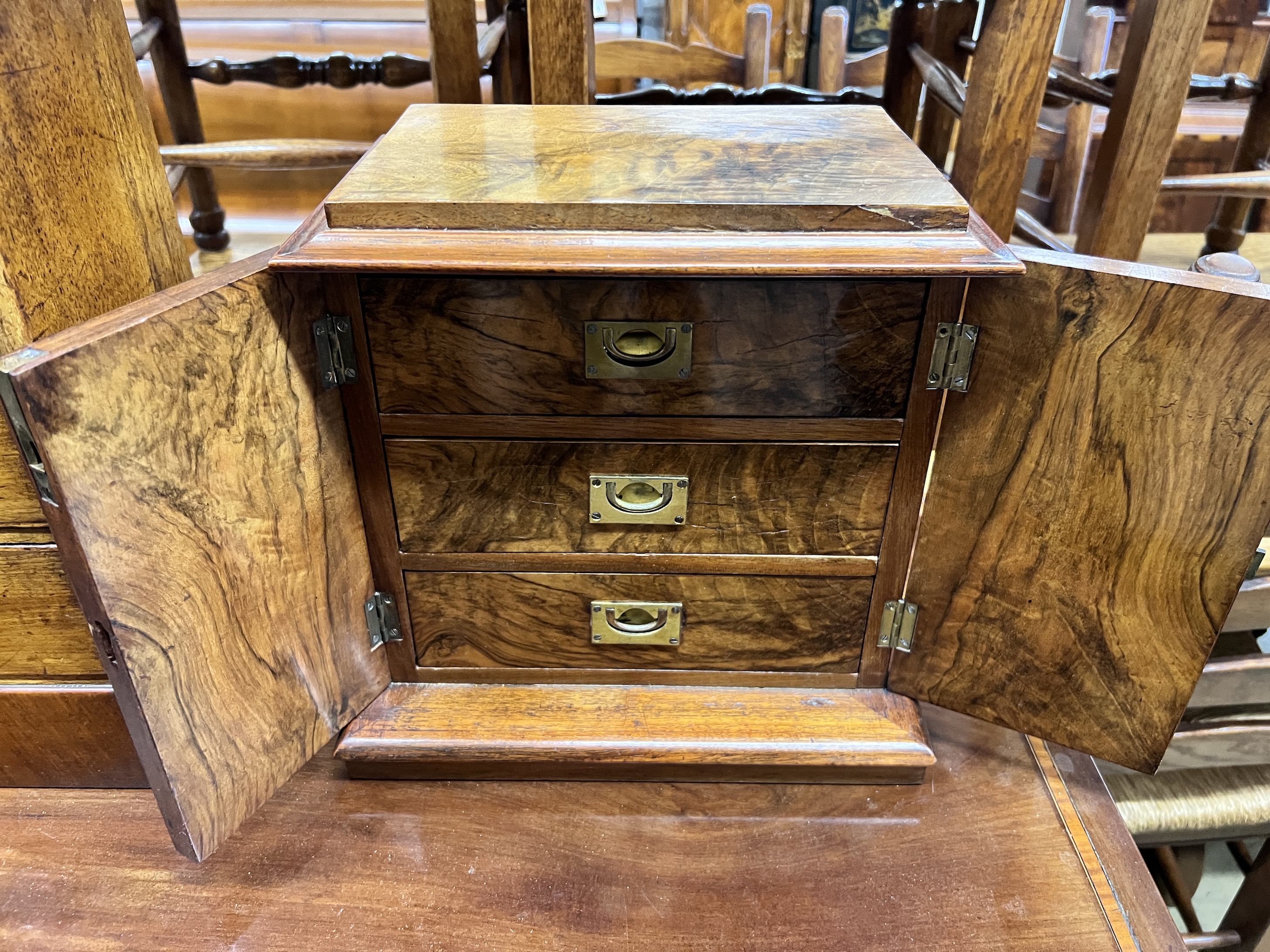 A Victorian figured walnut table cabinet fitted three drawers, width 32cm